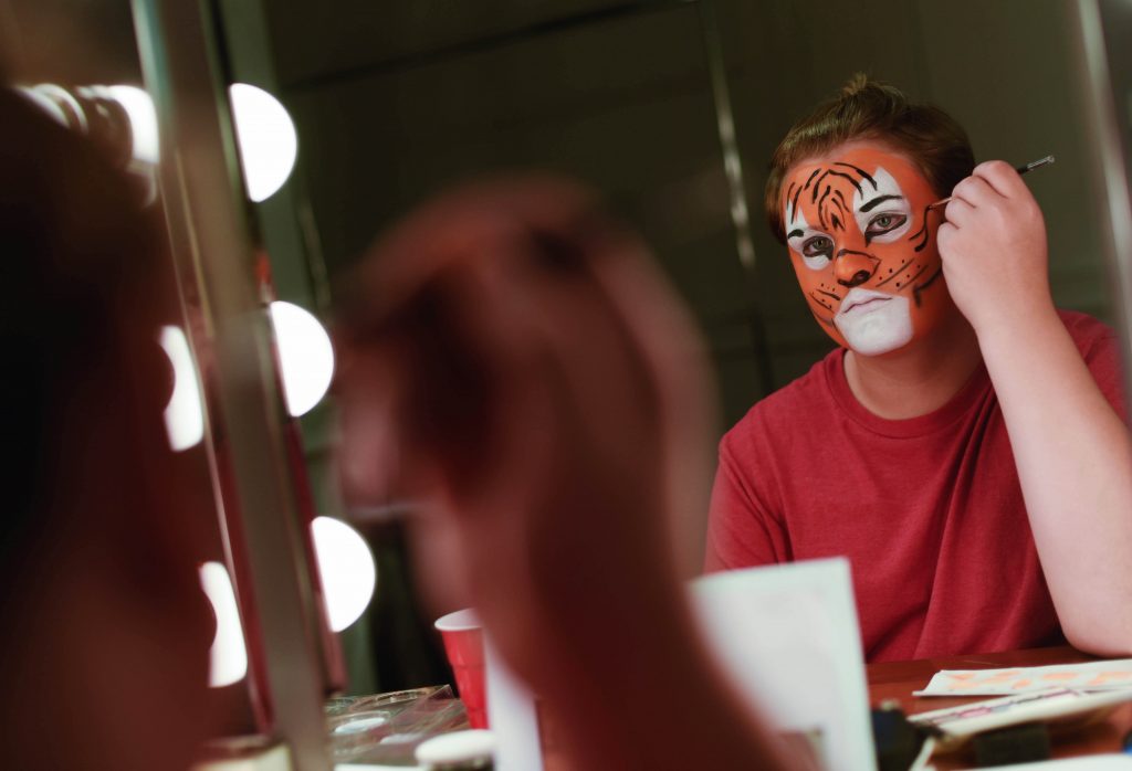 Students paint their faces in Stage and Special FX Makeup camp at Proctors Wednesday, July 19, 2017.