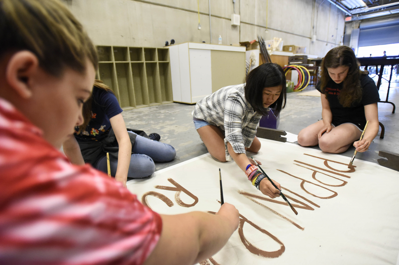 Students in the Broadway Camp: Production crew paint signs for Pippin backstage at Proctors Wednesday, July 12, 2017.